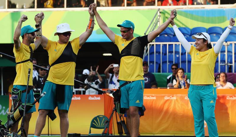 The Aussies celebrate winning bronze, but mostly being able to go to the beach now; Photo credit: Paul Gilham/Getty Images